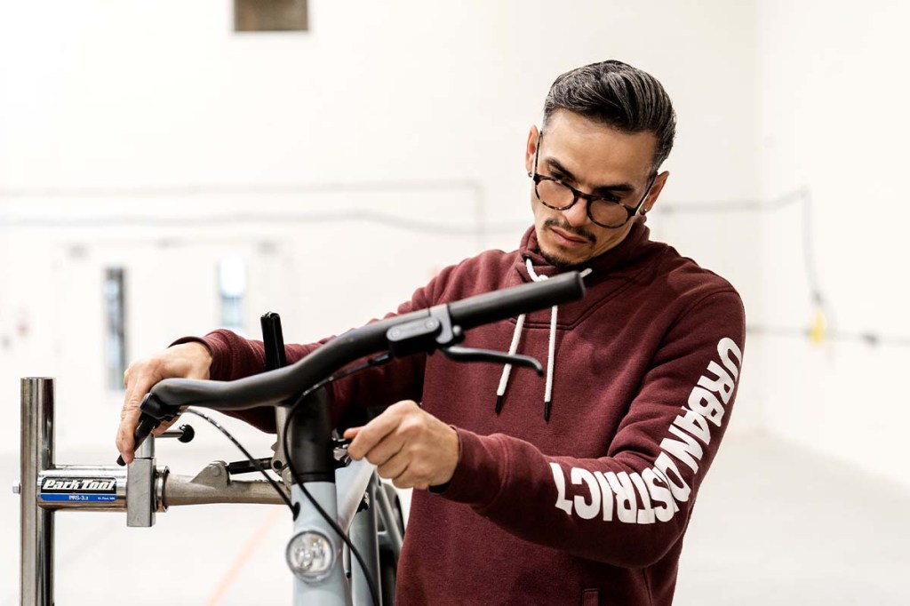 Mann repariert ein Fahrrad, Lenker im Anschnitt