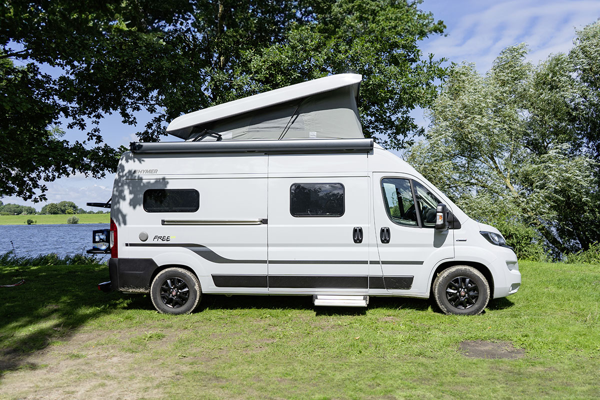 Seitliche Außenansicht des Camper Vans Hymer Free 600 mit aufgestelltem Hochdach.