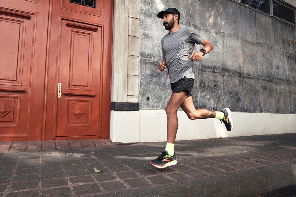 Mann beim Joggen vor einer Häuserfront