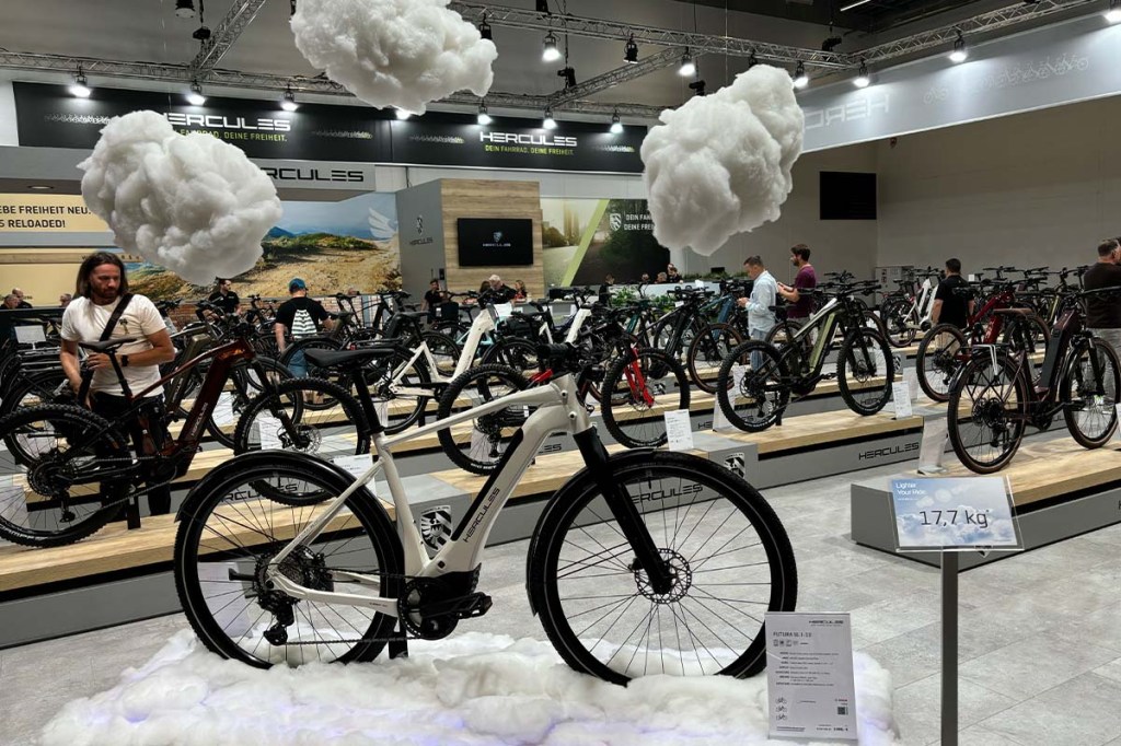 Fahrrad an einem Messestand, Wattewolken hängen von der Decke