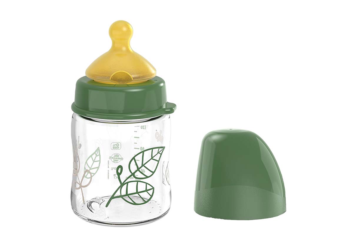 Baby-Trinkflasche mit grünem Muster, grüner Deckel liegt neben der Flasche, weißer Hintergrund