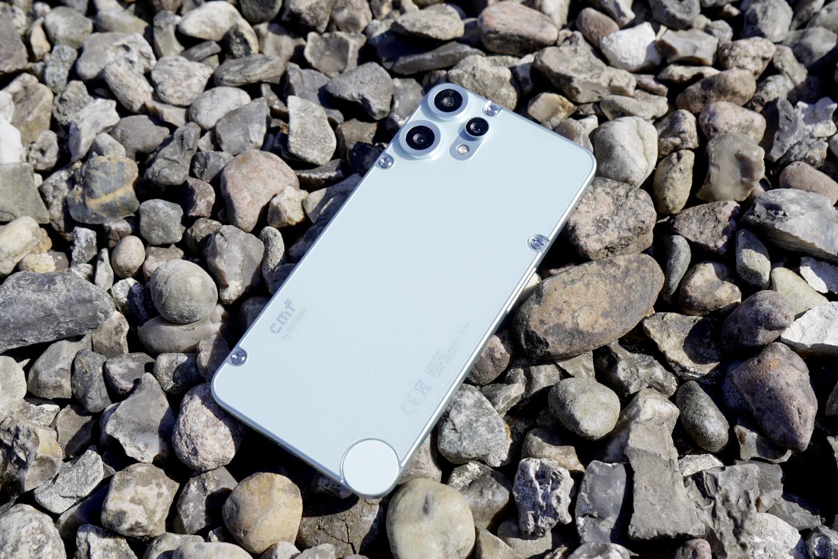 Das Smartphone CMF Phone 2 Pro liegt auf Kies.