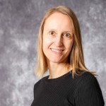 Porträt Kathrin Schräer auf grauem Hintergrund